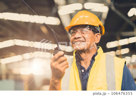Asian adult foreman supervisor happy using radio control operate project work job in heavy industry factory Asian adult foreman supervisor happy using radio control operate project work job in heavy industry factory 106476355
