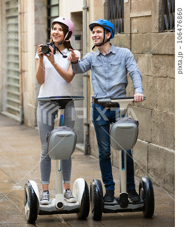couple traveling by segways couple traveling by segways 106476860