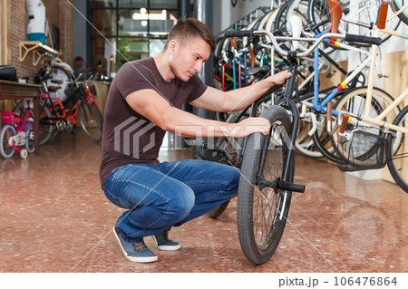 man is considering new bike 106476864