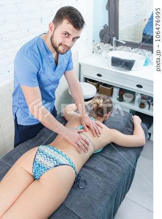 Massage therapist making massage to adult girl Massage therapist making massage to adult girl 106476995