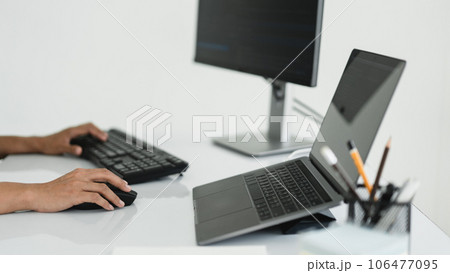 Hands of developer programmer using mouse and typing on keyboard to programming and developing web 106477095