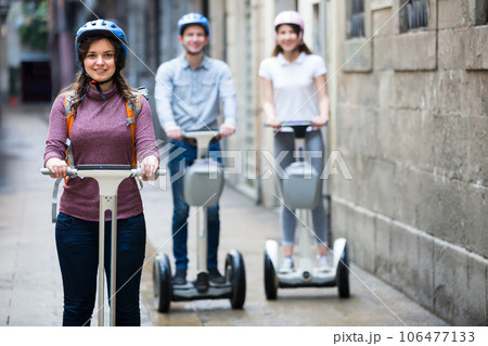 Three friends driving segways . 106477133