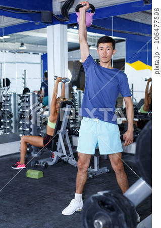 Man doing exercises with dumbbells 106477598