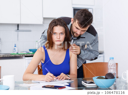 Upset young man with financial bills having conflict with woman Upset young man with financial bills having conflict with woman 106478116