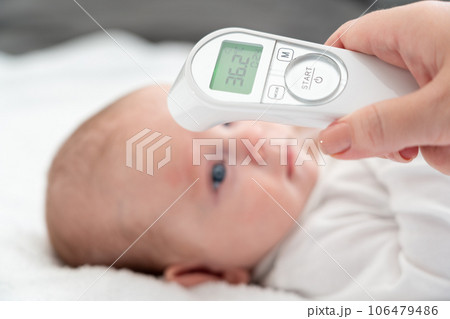 Digital tools aid a mother's health check on infant. Concept of technology in baby care Digital tools aid a mother's health check on infant. Concept of technology in baby care 106479486