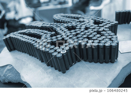 Emblem, coat of arms of Ukraine trident from used cartridges. Object made up of spent used cartridge cases. Lots used shells from cartridge cases ammo close up. Model from Many Used cartridge Cases. 106480245