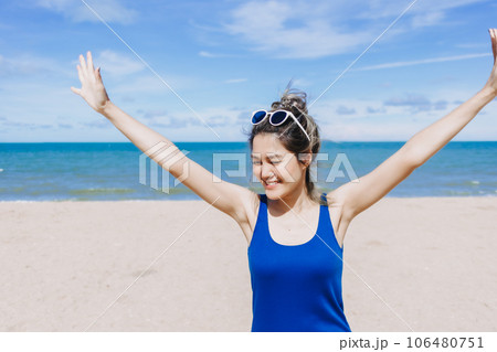 Happy and cheerful woman in blue dress on the sunny beach of Thailand. Happy and cheerful woman in blue dress on the sunny beach of Thailand. 106480751