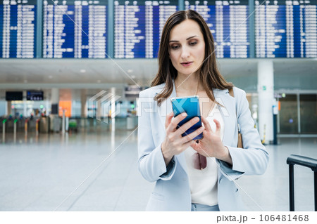 business woman at airport in front of display business woman at airport in front of display 106481468