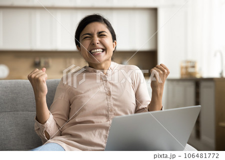 Overjoyed young freelance business woman celebrating triumph Overjoyed young freelance business woman celebrating triumph 106481772