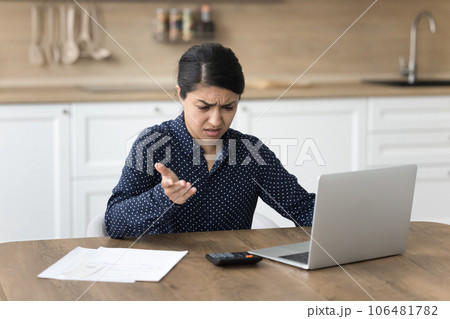 Concerned young Indian accountant woman annoyed by financial problems 106481782