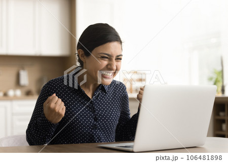Happy excited young Indian woman celebrating achievement 106481898