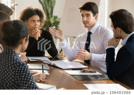 Diverse businesspeople brainstorm at office meeting together Diverse businesspeople brainstorm at office meeting together 106481988
