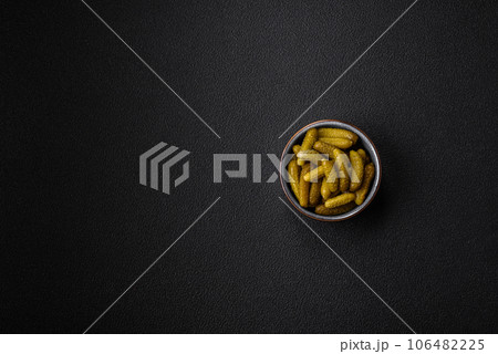 Delicious small pickled cucumbers gherkins with onions, mustard, salt and spices Delicious small pickled cucumbers gherkins with onions, mustard, salt and spices 106482225