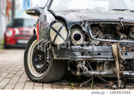 Auto accident. Crashed car in the street. Damaged civilian sport car after collision 106483088