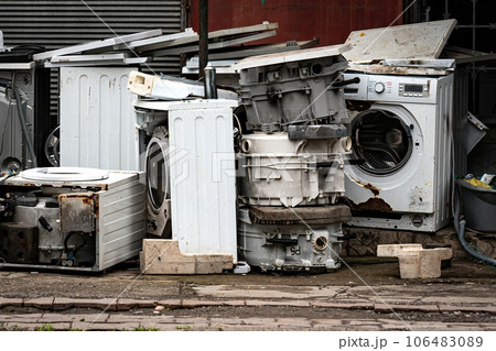 Broken White Washing Machines whole and detail parts on the street. Dump of scrap metal and household appliances Broken White Washing Machines whole and detail parts on the street. Dump of scrap metal and household appliances 106483089