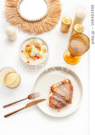 Delicious breakfast with fresh croissants and ripe berries on the white table 106483498