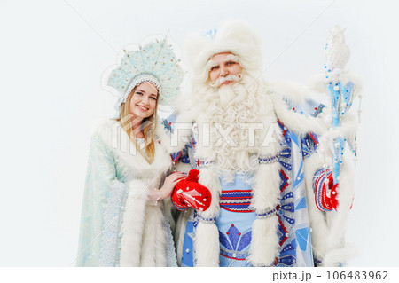 a traditional Father Frost and Snow Maiden costume on a white background. a traditional Father Frost and Snow Maiden costume on a white background. 106483962