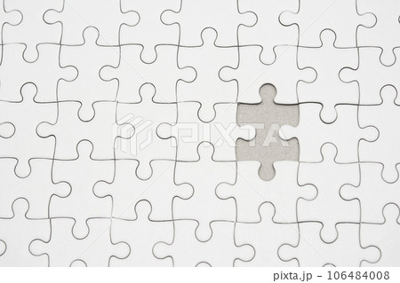 White jigsaw puzzle pattern background. placing last piece of jigsaw puzzle 106484008