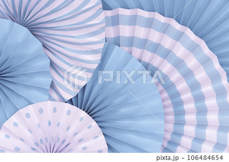 Blue background. Top view of two tones paper fans piled up in layers. 106484654