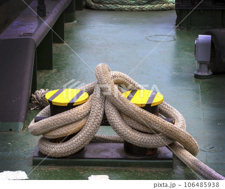 docked boat tied with nautical rope and knot 106485938