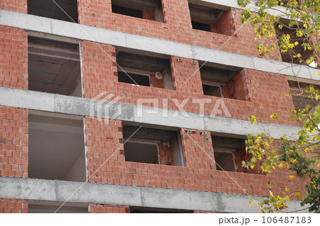 house under construction . Windows without glass 106487183