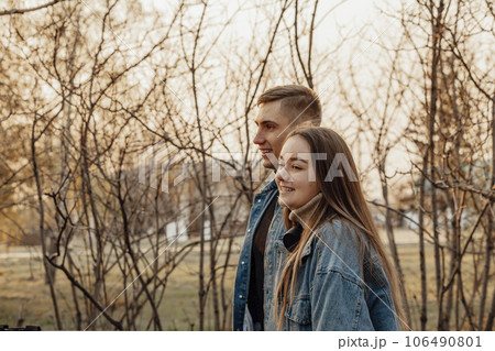 A couple in motion walks in the park in spring or autumn, happy lifestyle concept 106490801