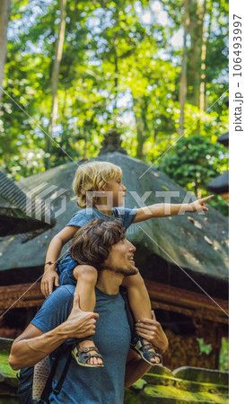 Dad and son travelers discovering Ubud forest in Monkey forest, Bali Indonesia. Traveling with children concept VERTICAL FORMAT for Instagram mobile story or stories size. Mobile wallpaper 106493997
