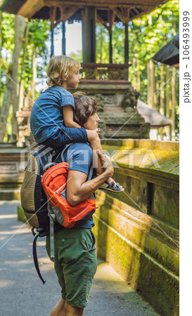 Dad and son travelers discovering Ubud forest in Monkey forest, Bali Indonesia. Traveling with children concept VERTICAL FORMAT for Instagram mobile story or stories size. Mobile wallpaper 106493999