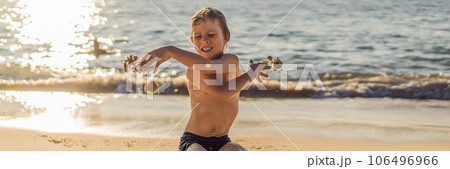 The boy screams and freaks out on the beach, throws sand. Tantrum concept BANNER, LONG FORMAT The boy screams and freaks out on the beach, throws sand. Tantrum concept BANNER, LONG FORMAT 106496966