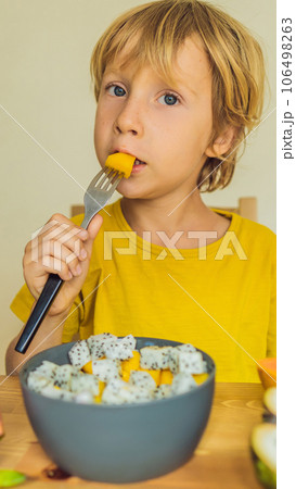 Boy eats fruit. Healthy food for children. Child eating healthy snack. Vegetarian nutrition for kids. Vitamins for children VERTICAL FORMAT for Instagram mobile story or stories size. Mobile wallpaper Boy eats fruit. Healthy food for children. Child eating healthy snack. Vegetarian nutrition for kids. Vitamins for children VERTICAL FORMAT for Instagram mobile story or stories size. Mobile wallpaper 106498263