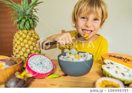 Boy eats fruit. Healthy food for children. Child eating healthy snack. Vegetarian nutrition for kids. Vitamins for children Boy eats fruit. Healthy food for children. Child eating healthy snack. Vegetarian nutrition for kids. Vitamins for children 106498395