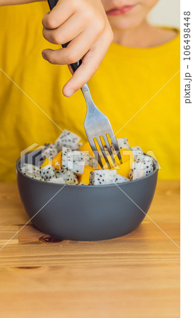 Boy eats fruit. Healthy food for children. Child eating healthy snack. Vegetarian nutrition for kids. Vitamins for children VERTICAL FORMAT for Instagram mobile story or stories size. Mobile wallpaper 106498448