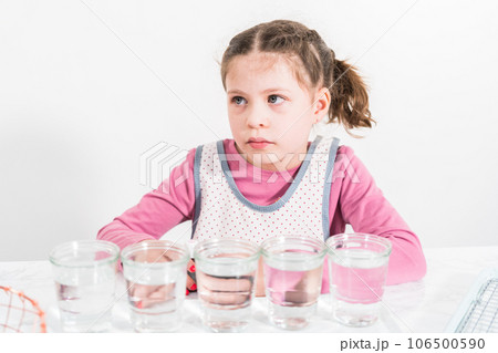 Easter egg coloring. Mixing food coloring with water and a dash of white vinegar to dye Easter eggs. 106500590