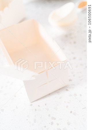 Packaging homemade chocolate fudge with peanut butter swirl into a white gift box. 106500691