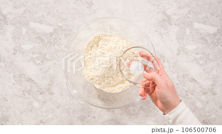 Flat lay. Step by step. Mixing ingredients in a glass mixing bowl to prepare coconut banana pancakes. Flat lay. Step by step. Mixing ingredients in a glass mixing bowl to prepare coconut banana pancakes. 106500706