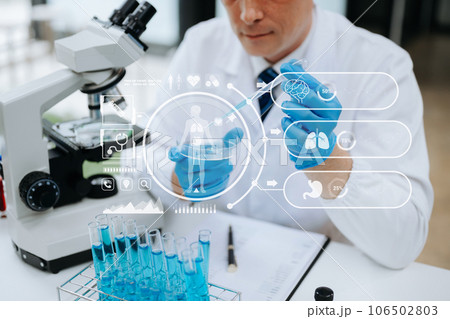 DNA molecule testing concepts. The doctor in a mask examines DNA molecules on the chemical laboratory with virtual icon. DNA molecule testing concepts. The doctor in a mask examines DNA molecules on the chemical laboratory with virtual icon. 106502803