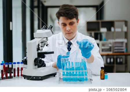 Modern medical research laboratory. female scientist working with micro pipettes analyzing biochemical samples, advanced science chemical laboratory . Modern medical research laboratory. female scientist working with micro pipettes analyzing biochemical samples, advanced science chemical laboratory . 106502804