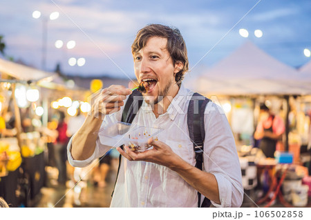 Young man tourist on Walking street Asian food market 106502858