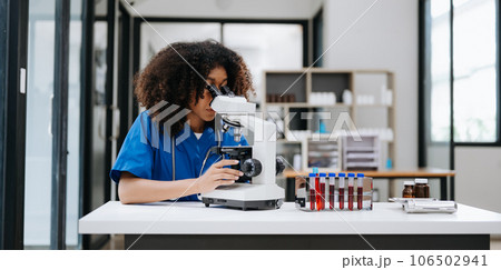 Modern medical research laboratory. female scientist working with micro pipettes analyzing biochemical samples, advanced science chemical laboratory . Modern medical research laboratory. female scientist working with micro pipettes analyzing biochemical samples, advanced science chemical laboratory . 106502941
