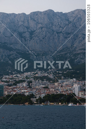 Midnight photo of city under the mountain. Beautiful landscape of sea and city Midnight photo of city under the mountain. Beautiful landscape of sea and city 106503328