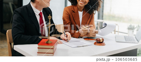 Business and lawyers discussing contract papers with brass scale on desk in office. Law, legal services, advice, justice and law concept ... Business and lawyers discussing contract papers with brass scale on desk in office. Law, legal services, advice, justice and law concept ... 106503685
