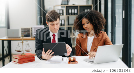 business people and lawyers discussing contract papers sitting at the table. Concepts of law, advice, legal services. in morning light. business people and lawyers discussing contract papers sitting at the table. Concepts of law, advice, legal services. in morning light. 106503848