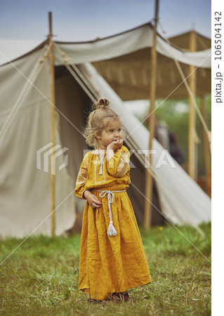 Charming child in embroidered dress at the viking festival in Denmark Charming child in embroidered dress at the viking festival in Denmark 106504142