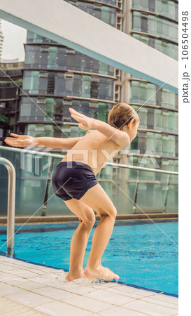 Malaysia, Kuala Lumpur November 21, 2018: Boy jumping into the pool among the skyscrapers and the big city. Relax in the big city. Rest from stress VERTICAL FORMAT for Instagram mobile story or Malaysia, Kuala Lumpur November 21, 2018: Boy jumping into the pool among the skyscrapers and the big city. Relax in the big city. Rest from stress VERTICAL FORMAT for Instagram mobile story or 106504498
