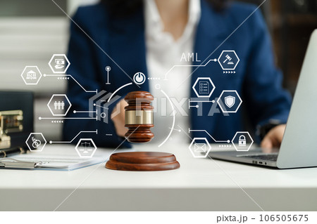 Justice and law concept. Female judge in a courtroom with the gavel working with digital laptop computer docking keyboard on table. Justice and law concept. Female judge in a courtroom with the gavel working with digital laptop computer docking keyboard on table. 106505675
