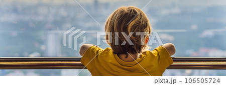 Little boy looks at Kuala lumpur cityscape. Panoramic view of Kuala Lumpur city skyline evening at sunset skyscrapers building in Malaysia. Traveling with kids concept BANNER, LONG FORMAT Little boy looks at Kuala lumpur cityscape. Panoramic view of Kuala Lumpur city skyline evening at sunset skyscrapers building in Malaysia. Traveling with kids concept BANNER, LONG FORMAT 106505724