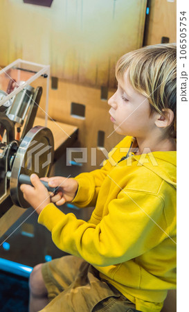 Smart boy scientist making physical experiments in the laboratory. Educational concept. Discovery VERTICAL FORMAT for Instagram mobile story or stories size. Mobile wallpaper Smart boy scientist making physical experiments in the laboratory. Educational concept. Discovery VERTICAL FORMAT for Instagram mobile story or stories size. Mobile wallpaper 106505754