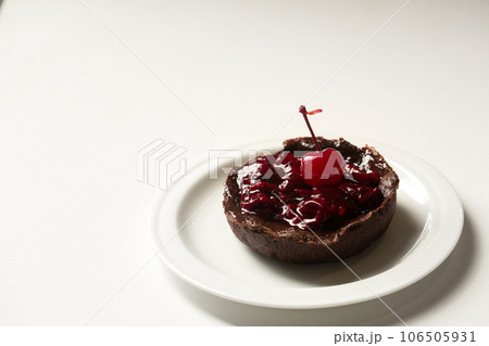 Delicious dessert with lingonberry jam on a white plate Delicious dessert with lingonberry jam on a white plate 106505931