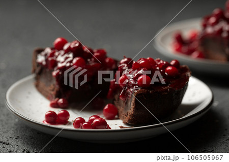 two small portions of chocolate cake on a dark background two small portions of chocolate cake on a dark background 106505967