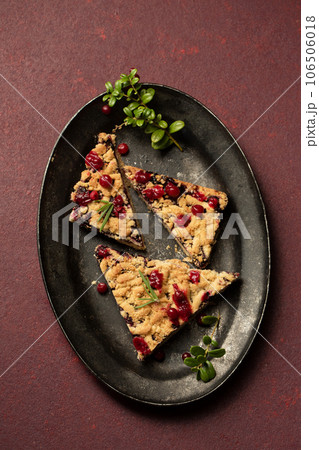 delicious crumble with lingonberry jam on a dark tray 106506018